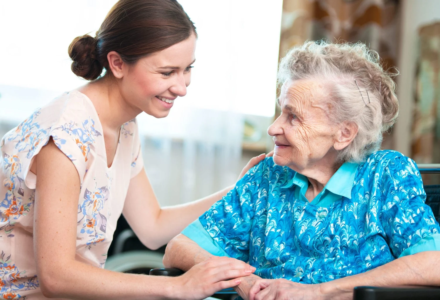 An older woman enjoying a warm conversation with a companion; photograph reused from the current GoHelpDo site